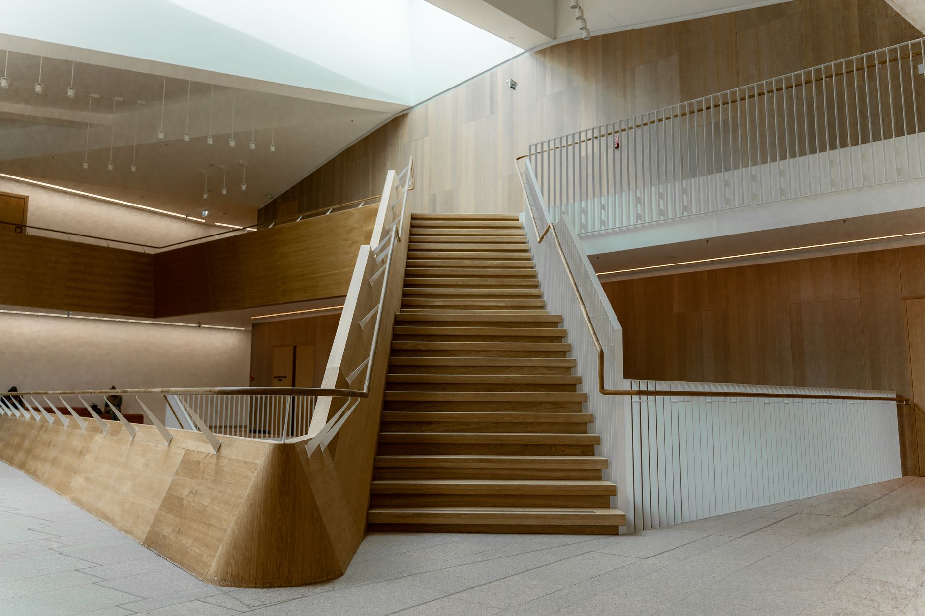 A sculptural indoor staircase in a modern public building.